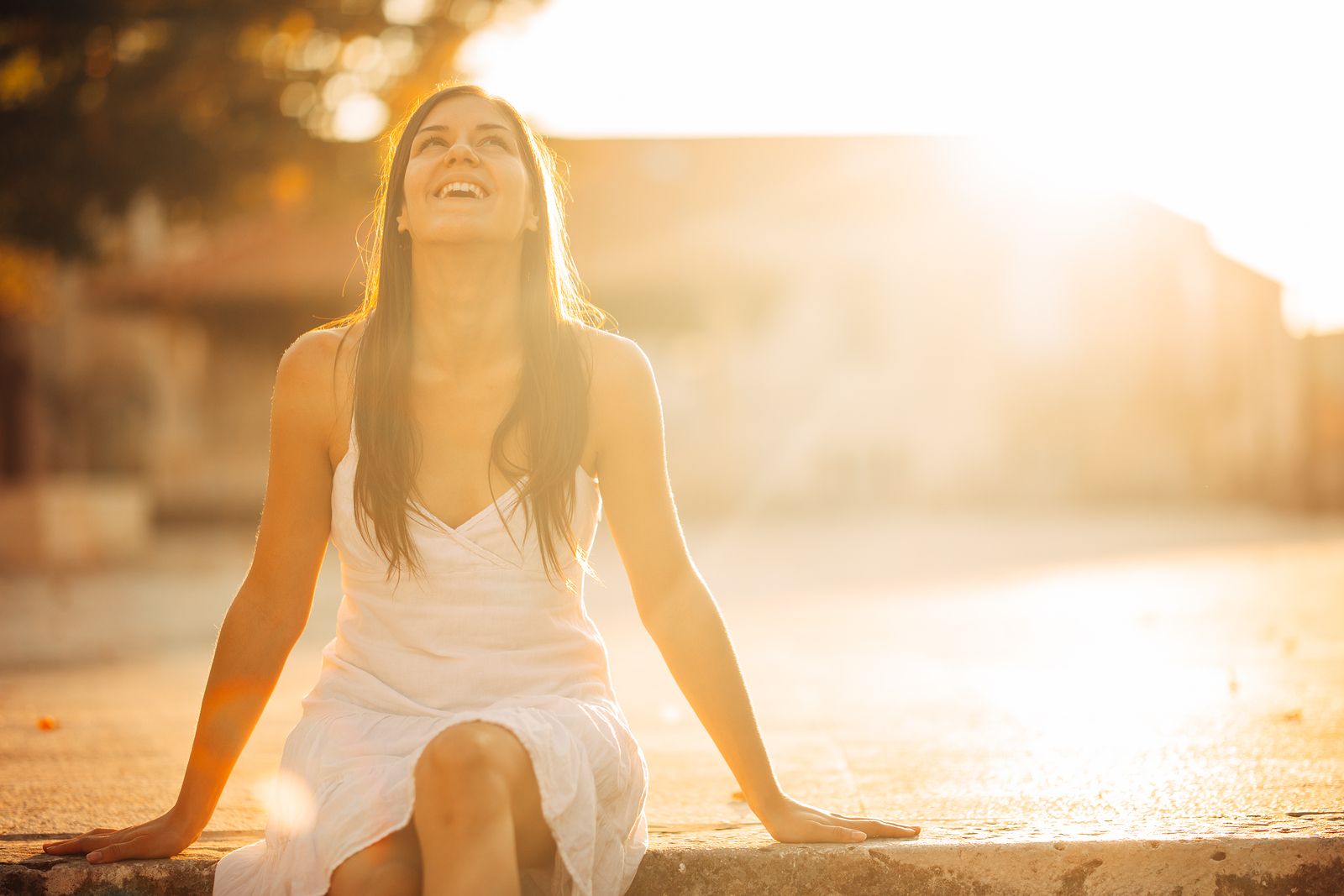 Carefree woman enjoying in nature, beautiful red sunset sunshine. Finding inner peace and spiritual healing through trauma therapy in Tigard, OR