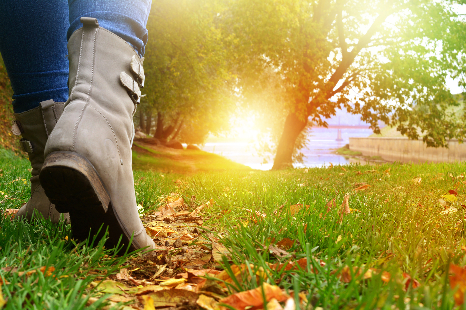 Female legs in grey shoes and jeans walking on the autumn forest path with yellow leaves | Depression Therapist | Christian Counseling in Tigard, OR 97223