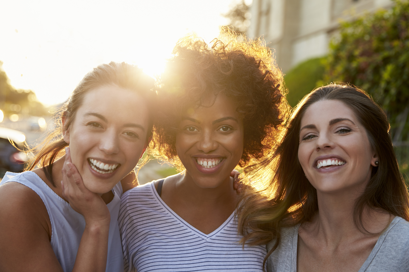 Group of three women looking at the camera and smiling after Relationship Therapy in Tigard, OR. Solve friendship and relationship problems. Marriage Counseling also available.