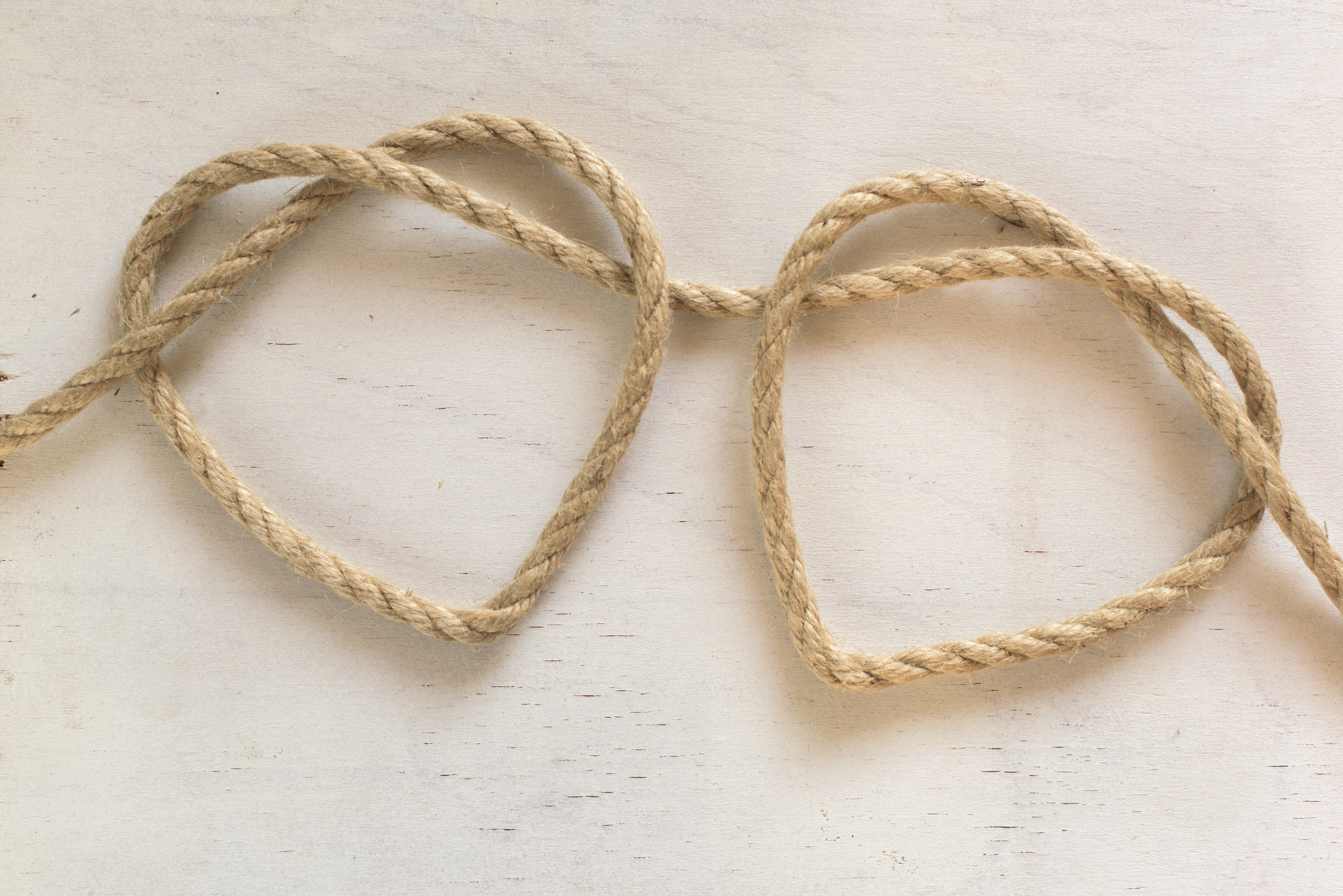 Two hearts made of one string of burlap to show the tie that binds two hearts as one in marriage and committed relationships. Marriage therapy can help your relationship problems in Tigard, OR