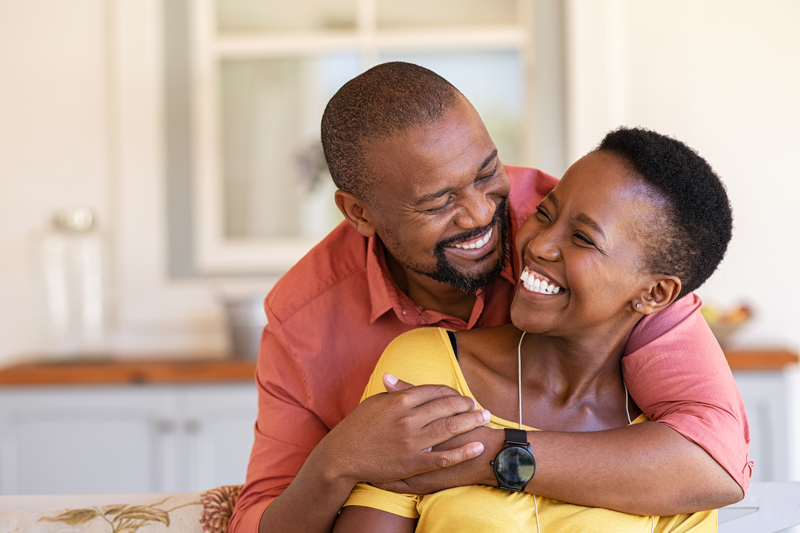 Married couple, smiling in an intimate and comfortable embrace after marriage counseling in Tigard, OR | Portland area couples therapy experts can help