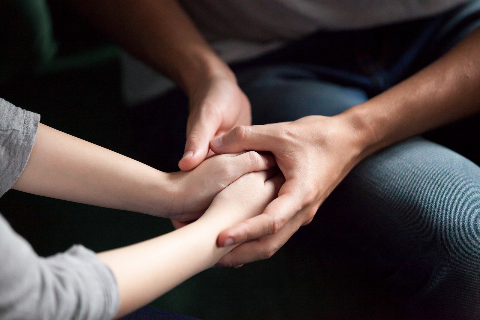 Couple holding both hands, could be a relationship problem called codependency which can be treated in codependency therapy in Tigard, OR