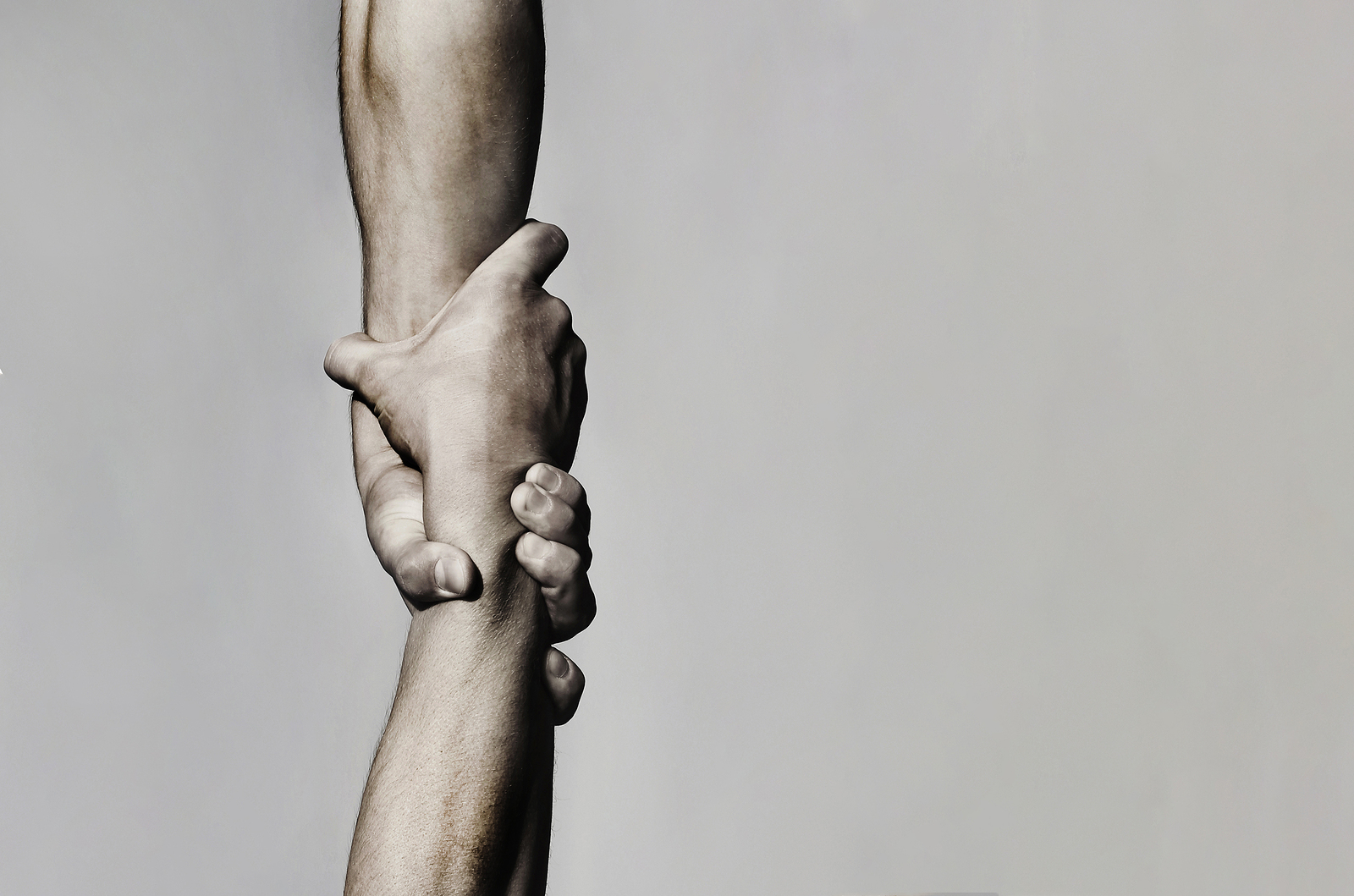 Hand helping another person rise. Could be a symbol of codependency problems but could also be a helpful and healthy relationship. Codependency counseling in Tigard, OR can help you be more secure and confident at Discover Counseling