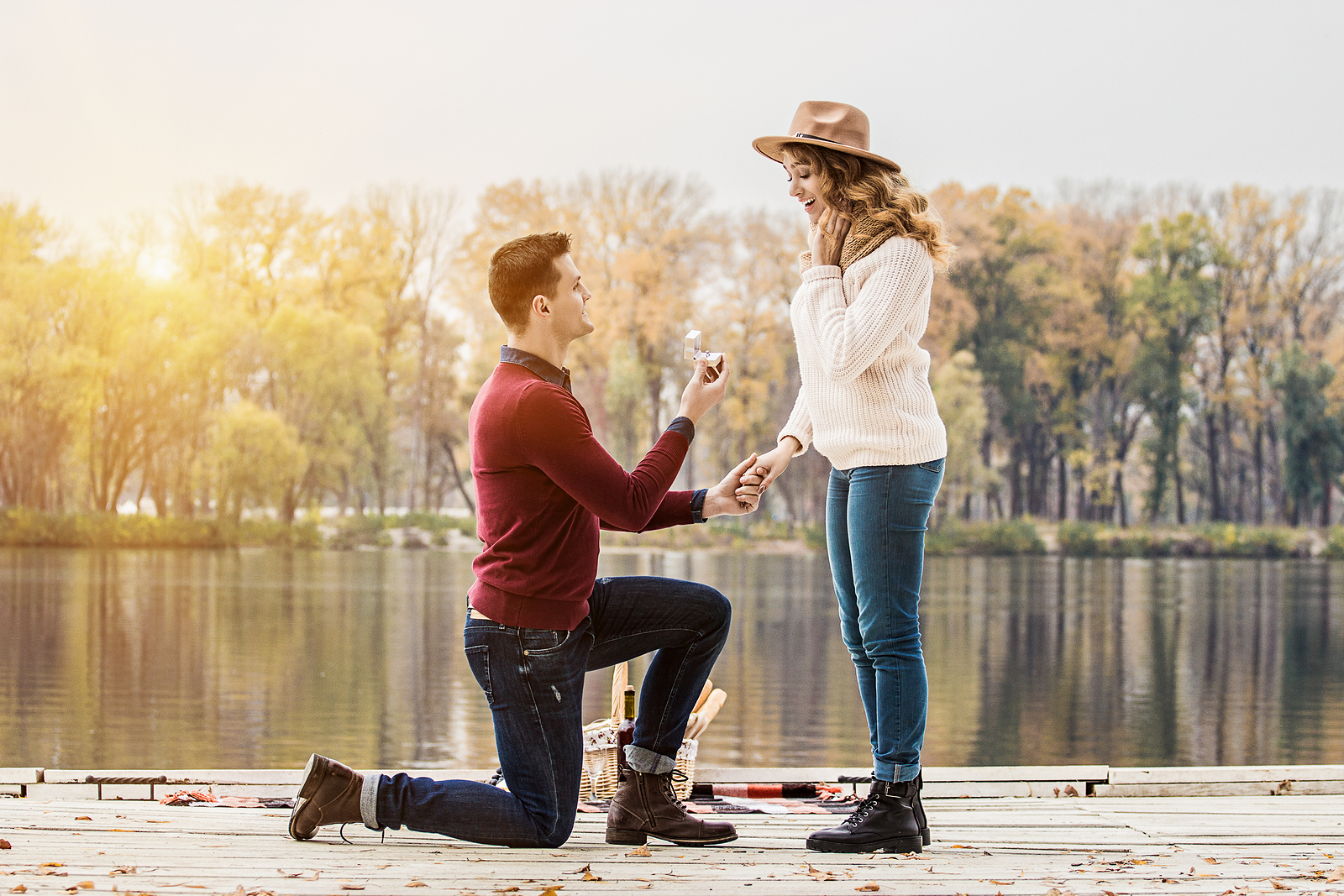 Couple getting engaged in front of the water. Premarital therapy